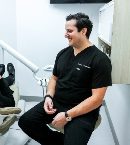 Woman smiling during dental checkup in New York dental office