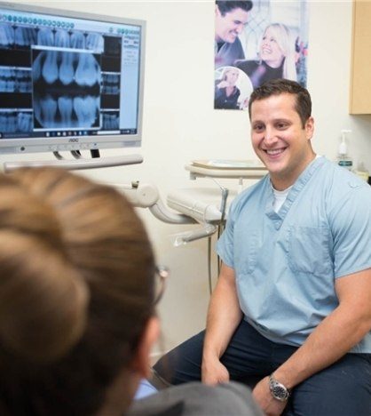 Doctor Leonetti smiling at a dental patient