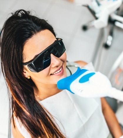Woman getting professional teeth whitening in New York dental office