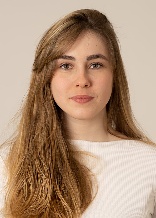 Woman with long brown hair smiling gently, a patient at our Union Square oral surgeon NYC practice